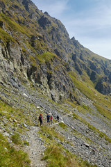 Fototapeta na wymiar Tourists hiking on mountain trail