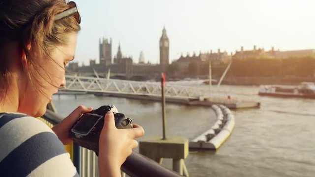 Tourist photographer filming London Eye Big Ben Sightseeings at sunset