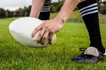 Rugby player about to kick ball