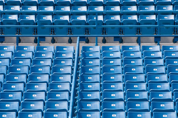 Fototapeta premium Blue seats in a sports stadium.