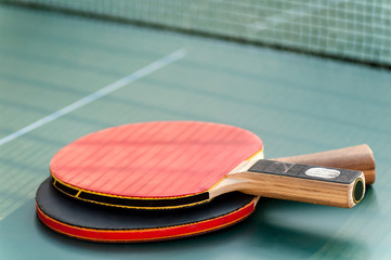 two tennis racket  on the table with a grid