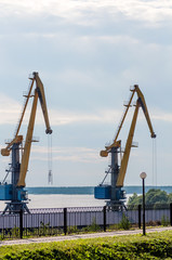 Fototapeta na wymiar two cranes in the port view from the embankment