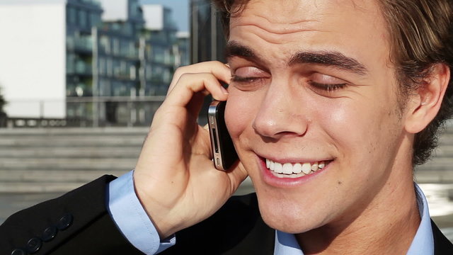 Businessman talking on mobile phone outdoors