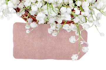 card among the lilies of the valley on a white background