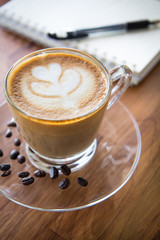 Tulip latte art coffee on wooden background