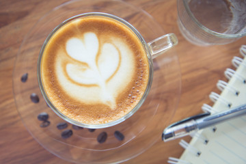 Tulip latte art coffee on wooden background