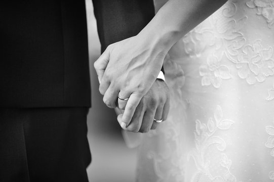 Hands of the newlyweds with rings