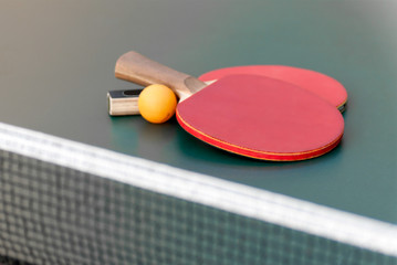 two tennis racket and a ball on the table with a grid