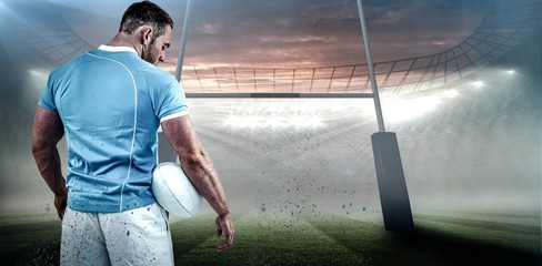 Composite image of rugby player standing with ball © vectorfusionart