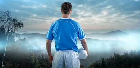 Composite image of rugby player holding a rugby ball © vectorfusionart