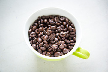 Roasted coffee in green cup