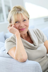 Portrait of senior woman relaxing in couch