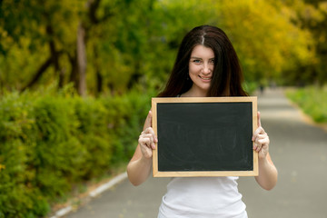 Fototapeta premium girl with a school board in the hands of