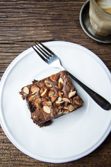 Cake chocolate brownies on wooden table in the coffee shop