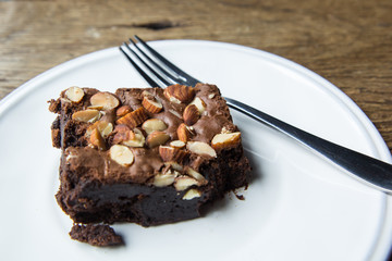 Cake chocolate brownies on wooden table in the coffee shop