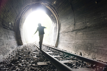 Child walking in railway tunnel