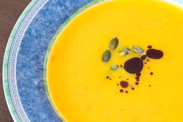 Fresh pumkin soup with pumkin oill and seeds