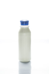 Bottle of milk isolated on white, selective focus