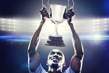 Composite image of happy sportsman looking up 