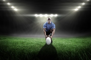 Composite image of portrait of rugby player holding ball