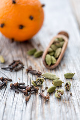 Spices and orange with clove buds.