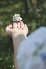 Hand hold small cup of coffee