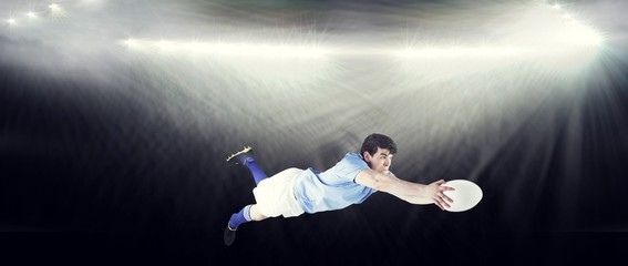 Composite image of a rugby player scoring a try