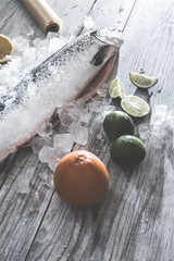 Fototapeta na wymiar Raw salmon fish in ice and vegetables