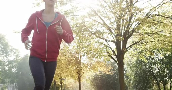 Runner woman running in park exercising outdoors