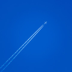 Airplane In The Sky With Plane Trails