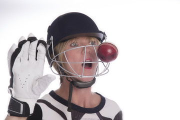 Cricketer wearing safety helmet being hit by a cricket ball