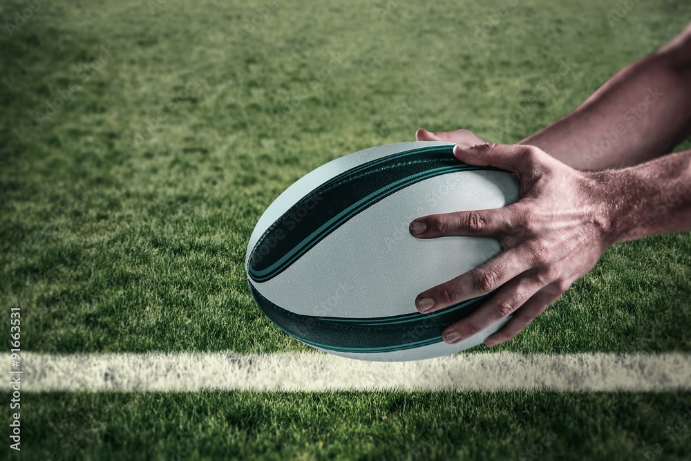 Wall mural composite image of cropped image of sports player holding ball