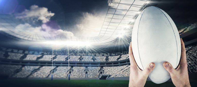 Composite image of rugby player catching a rugby ball