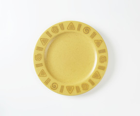 Handmade pottery plate with decorated rim