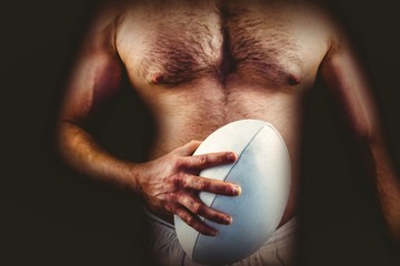 Shirtless rugby player holding ball © vectorfusionart
