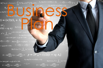 the businessman is writing Business Plan on the transparent boar
