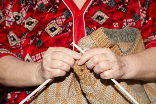 Old Woman And Knitting Sweater