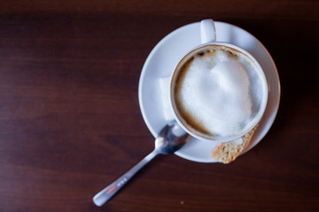 Cappuccino Coffee on wooden table background