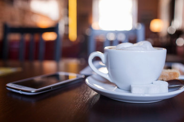 Cup of Cappuccino on wooden table. Cafe.
