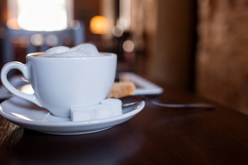 Cup of Cappuccino on wooden table. Cafe.