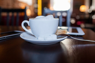 Cup of Cappuccino on wooden table. Cafe.