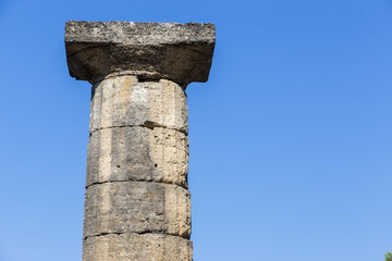 Fototapeta na wymiar Remains of Corinthian column in Olympia, Greece