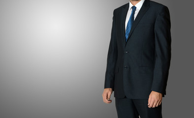 Close up of businessman in suit over dark gray background with c