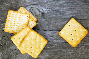 Biscuits salty crackers on an old wooden background
