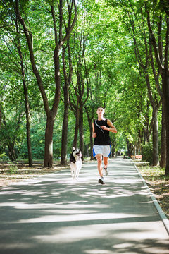 work out with dog. Young caucasian male running with siberian hu