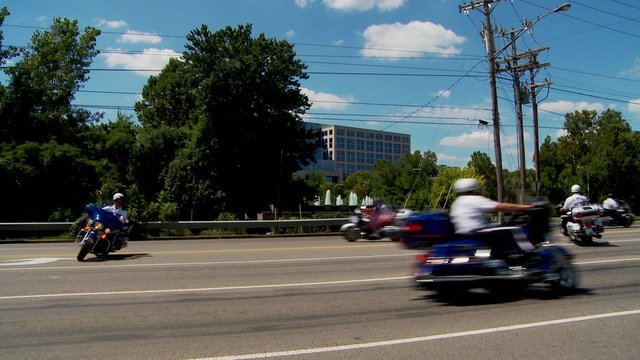 A Shriner's parade features motorcycles traveling in circles.