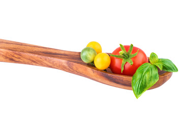 fresh tomatoes on wooden spoon