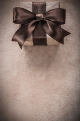 Gift box with tied ribbon paper on vintage background