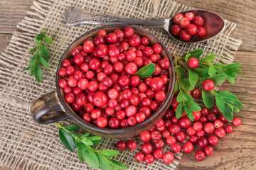 Lingonberry over burlap background, top view