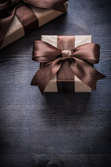 Gift boxes with brown tied ribbons on vintage wooden surface